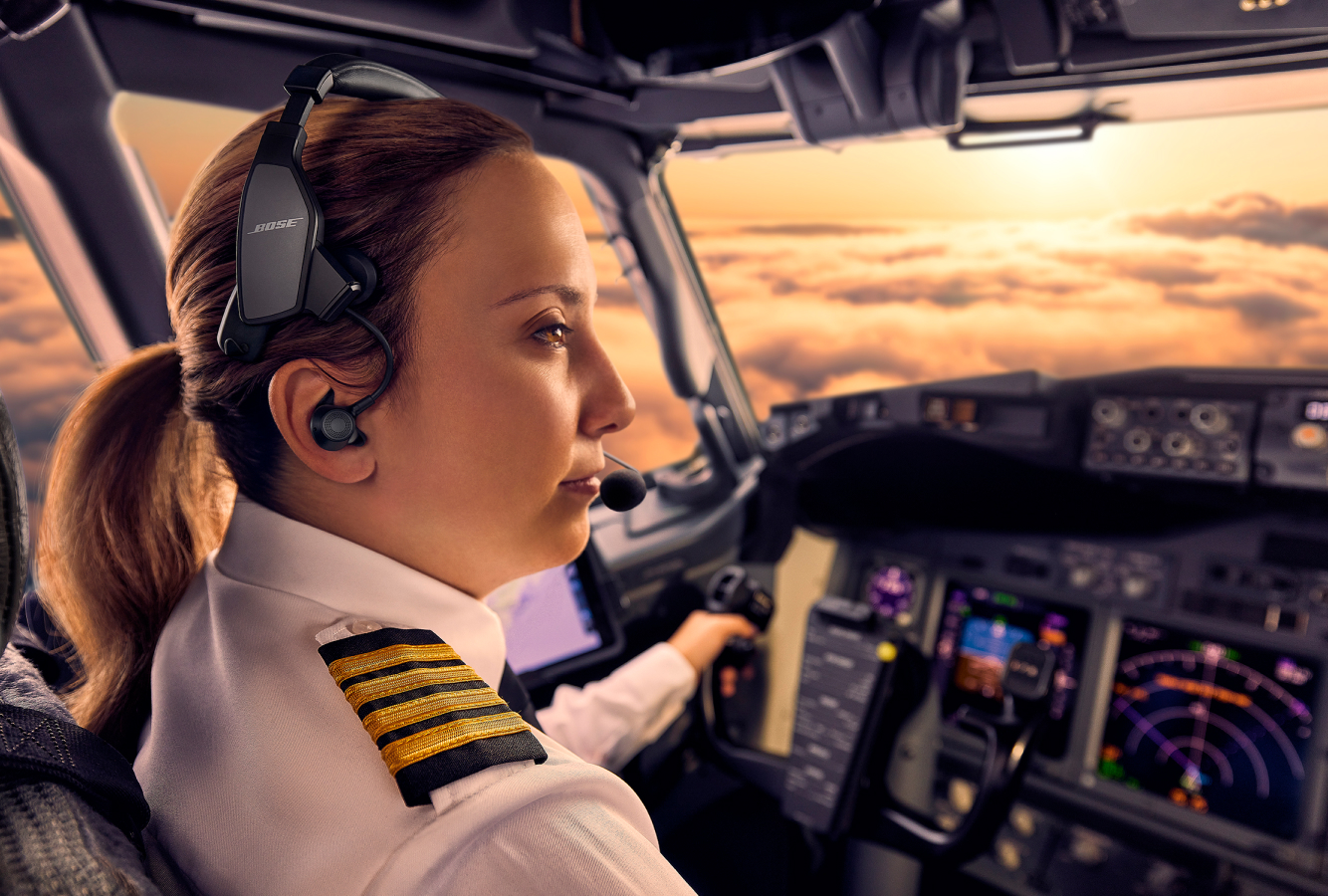 Pilot in cockpit wearing Bose Aviation ProFlight Headset